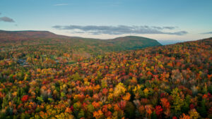 Aerial shot of Haines Falls, New York and surrounding woodlands in autumn at sunset