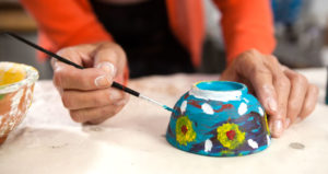 hand painting a small bowl