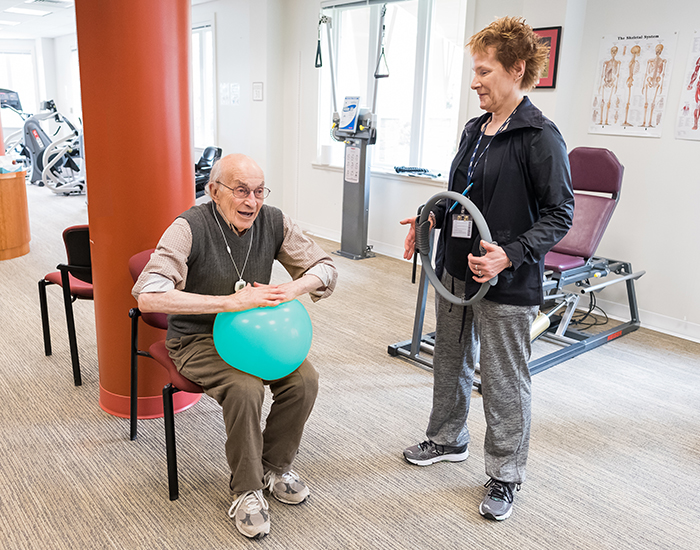 Resident exercising with staff supervision
