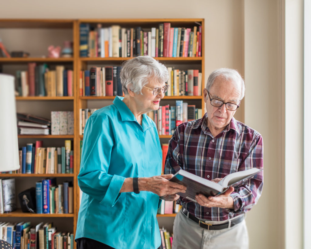 Resident couple looking up information in a book