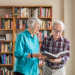 Two residents looking over information in a book