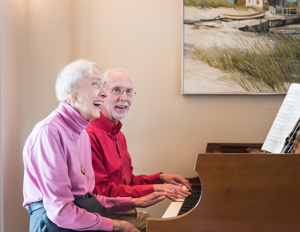 Two residents sitting at the piano