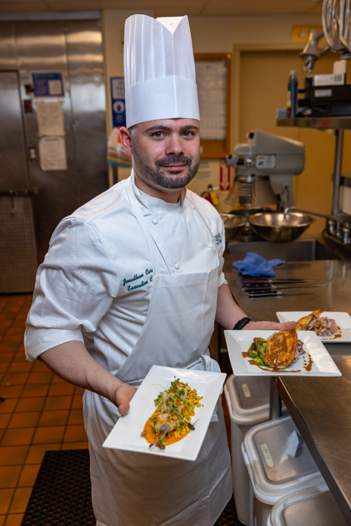 Chef Jonathan ready to serve plated dishes