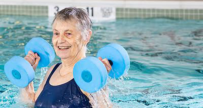 senior woman exercising in pool