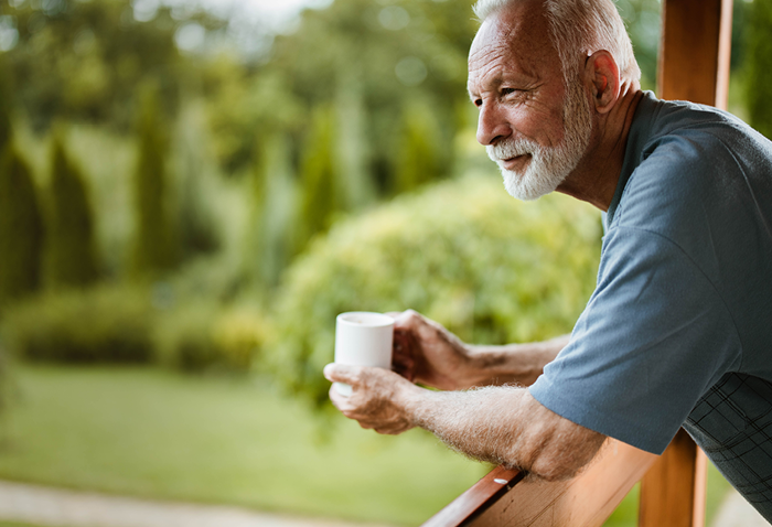 senior man drinking coffee on his patio