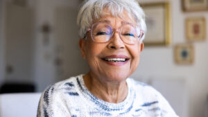 senior woman smiling in a sweater