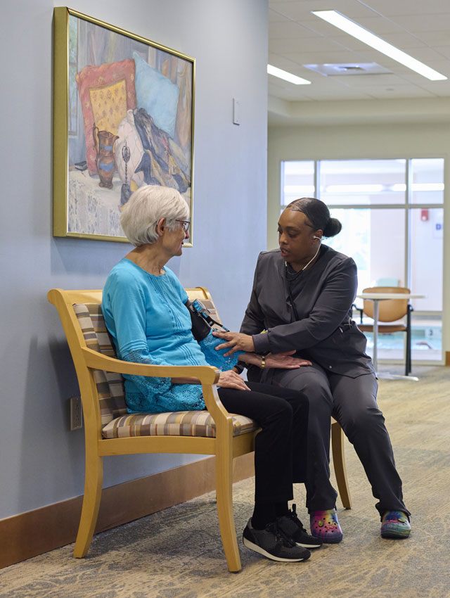 senior woman getting her blood pressure checked by a nurse