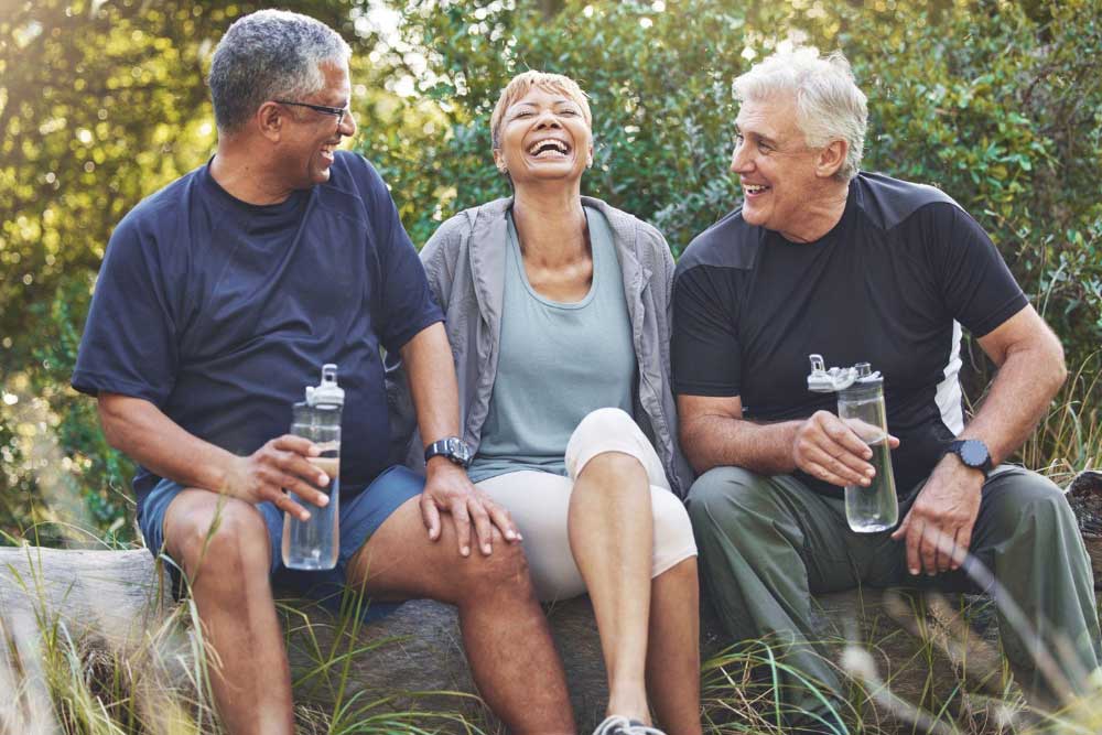 a group of active seniors laughing outside together