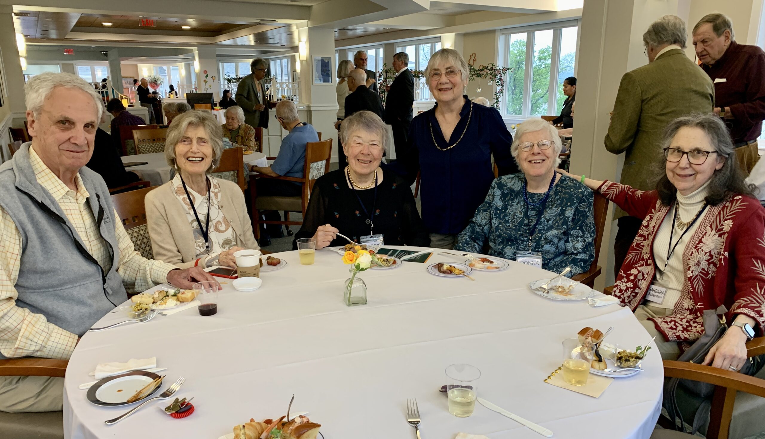 Seniors smile at table during Kendal on Hudson's 20th anniversary party