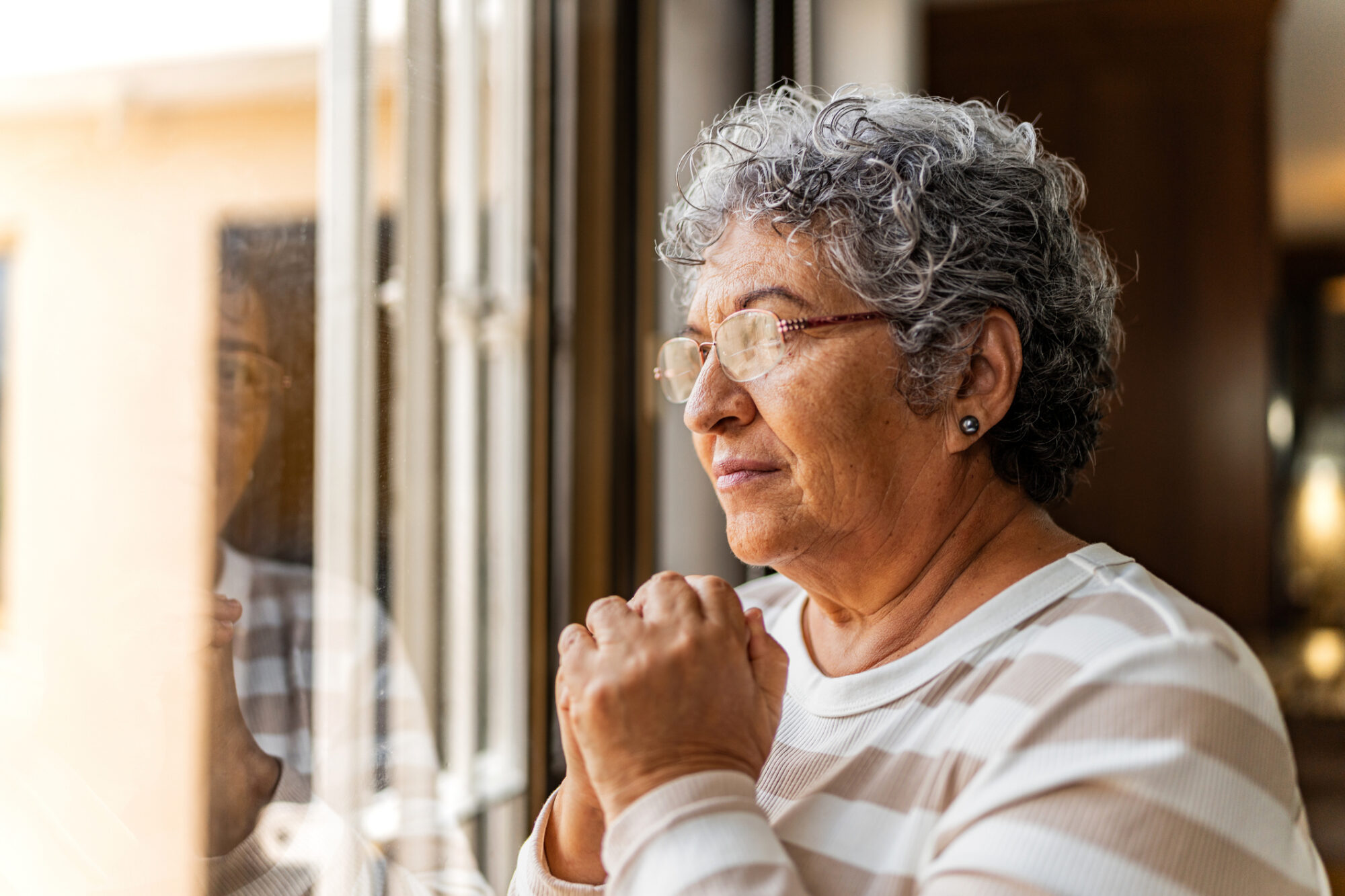 senior woman looking out window